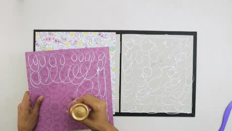 Applying-liquid-glue-on-decorative-paper-to-create-scrapbook-cover