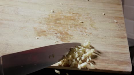 Chopped-Garlic-Falling-From-Wooden-Board
