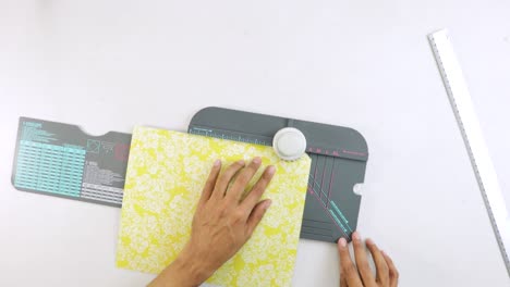 Punching-cutouts-in-yellow-paper-with-ornaments-on-123-punch-board