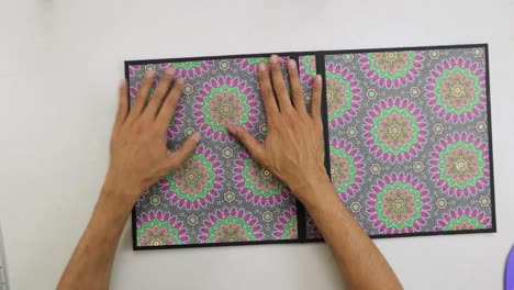 Gluing-paper-with-mandala-ornaments-on-cover-of-ring-binder-scrapbook