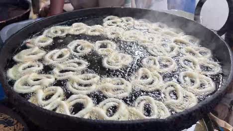 A-man-preparing-fresh-hot-jalebi-in-a-road-side-stall-in-India