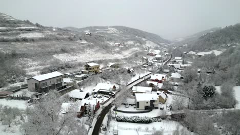 Aerial-shot-over-a-village-covered-in-snow