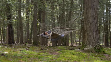 Carefree-Puerto-Rican-female-slowly-swinging-in-woodland-hammock-contemplating-life