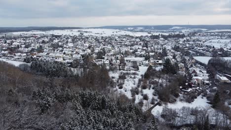 Aerial-view-of-the-town-Steinenbronn-in-the-Schönbuch-region-in-southern-Germany-covered-in-snow-during-winter
