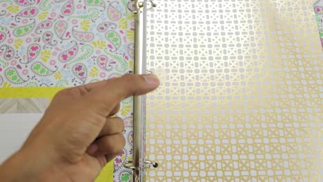 Using-ring-binder-reinforcers-for-shiny-ornate-paper-pages-in-file