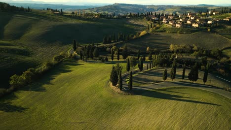 Drown-descends-orbitting-around-winding-road-down-picturesque-mountain,-Val-d'Orcia-Tuscany