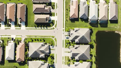 Aerial-of-a-top-down-view-of-a-sunny-suburban-neighborhood-in-tropical-climate-and-road