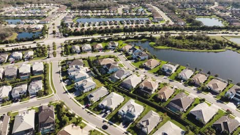 Aerial-of-a-sunny-suburban-neighborhood-in-tropical-climate-flying-over-hundreds-of-homes