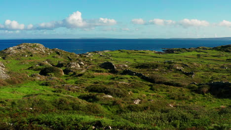 Aerial-drone-footage-of-Connemara's-lush-greenery,-the-Atlantic-Ocean,-and-the-Burren,-descending-to-a-house-entrance-in-Galway,-Ireland