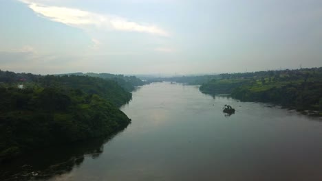 Aerial-View-Of-The-Nile-River-Flowing-Through-Rural-Landscape-At-Sunrise-In-Africa