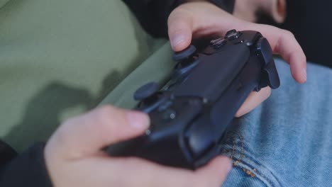 Close-up-on-person's-hands-using-a-video-game-controller