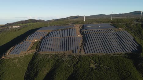 Aerial-view-of-a-photovoltaic-farm-and-a-wind-farm-on-top-of-a-mountain-in-Paul-da-Serra-Madeira-island