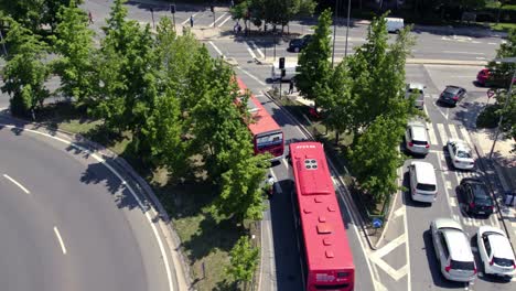 Aerial-Drone-Fly-Above-Street-Traffic-of-Santiago,-Chile-in-Summer,-Cars-Drive-along-Junction,-Red-Buses,-Public-Transportaton