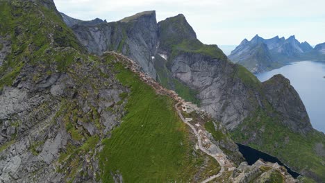 People-Hike-Stairs-to-Reinebringen-Viewpoint-at-Lofoten-Islands,-Norway---4k-Aerial