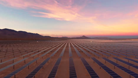 Solar-Panels-in-a-Desert-Solar-Farm-at-Dawn-or-Dusk-During-Golden-Hour,-Aerial