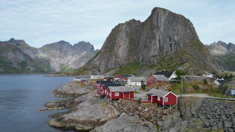 Red-cabin-houses-'Rorbuer'-at-Hamnoy-village,-Lofoten-Islands,-Norway---Pan-Left