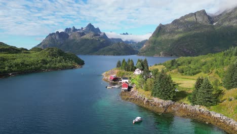 Lofoten-Islands-Red-Cabins,-Holiday-Homes-and-Nature-Landscape-at-Fjord-in-Norway---Aerial-4k