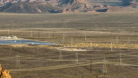 Solar-Farm-Revealing-Behind-A-Nevada-Desert-Mountain,-Aerial