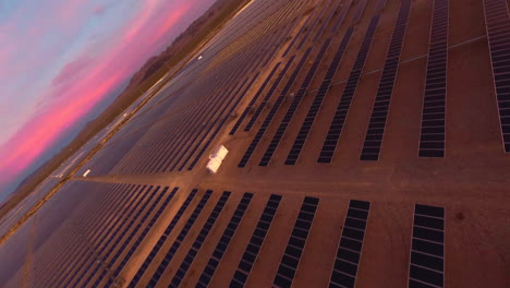 FPV-Drone-Flying-Through-Solar-Farm-in-a-Desert-During-Golden-Hour-at-Dawn-or-Dusk