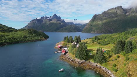 Lofoten-Islands-Red-Cabins,-Holiday-Homes-and-Nature-Landscape-at-Fjord-in-Norway---Aerial-4k-Circling