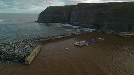 Establishing-Drone-Shot-of-Staithes-Harbour-Out-to-Sea-Yorkshire-UK
