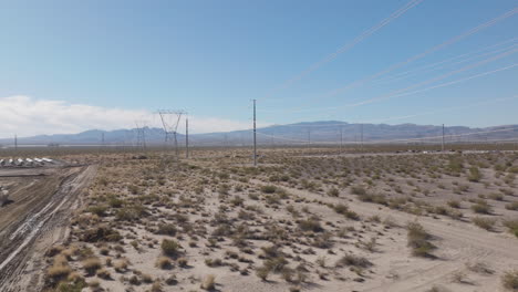 High-Tension-Transmission-Lines-in-a-Rural-Desert,-Aerial