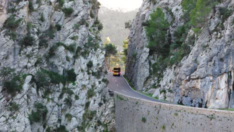 Bus-On-The-Road-Between-Rock-Formation-In-Majorca