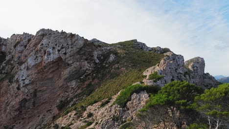 Aerial-Panoramic-View-Past-Green-Cliffs-Of-Cap-De-Formentor,-Majorca