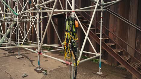 push-in-shot-of-scaffold-safety-climbing-equipment-and-harness-hanging-on-scaffolding