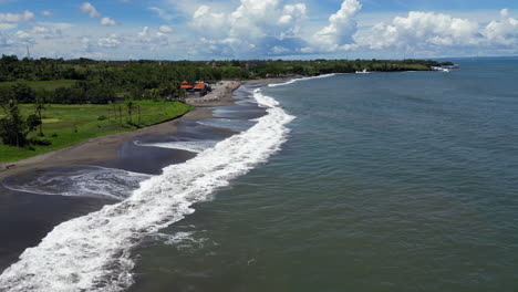 Empty-Bali-Beach-As-Drone-Tracks-Out-Over-Waves-In-Indonesia