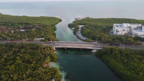 Aerial-rising-shot-of-cars-driving-over-the-Punta-Nizuc-Bridge-towards-hotels