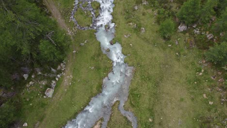Aerial-view-of-the-picturesque-Gschwandbach-mountain-stream-in-the-tyrolean-alps-around-the-Pitztal-valley-in-Austria