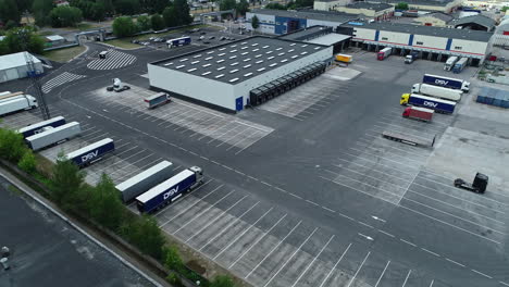 Aerial-drone-view-of-a-cargo-terminal-with-trucks-and-marked-lanes