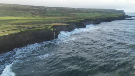 Aerial-dolly-shot-along-the-rocky-Doolin-cliff-edge-with-waves-crashing