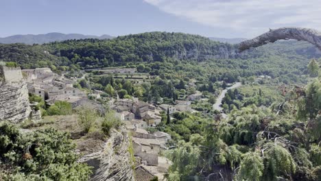 Small-French-village-on-a-hill-between-mountains-and-in-the-middle-of-nature-with-old-stone-houses-in-the-sunshine
