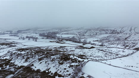 Establishing-Aerial-Drone-Shot-of-Yorkshire-Dales-on-Snowy-and-Foggy-Day-UK