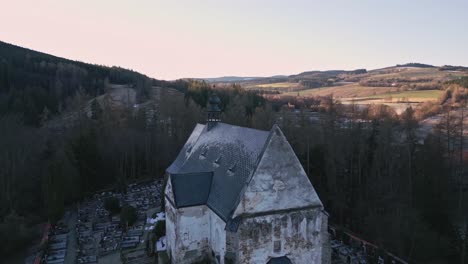 A-drone-flies-over-the-roof-of-the-Gothic-church-in-Velhartice