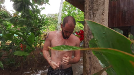 caucasian-male-shower-in-wild-jungle-of-hotel-resort-spa-in-Costa-Rica-Central-America