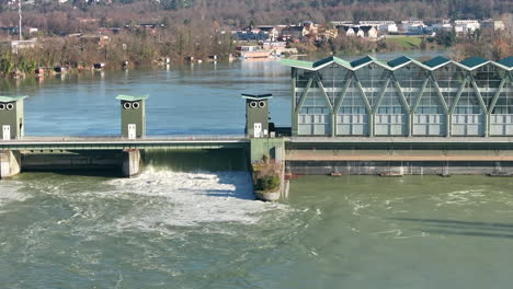 Birsfelden-hydropower-plant-by-high-water-on-sunny-afternoon-3x-boom-tilt
