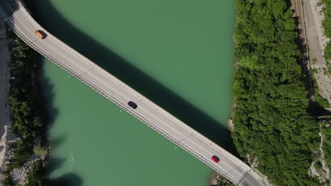 Bridge-on-the-Neretva-river-in-Bosnia-city-from-above,-vehicles-crossing-the-bridge