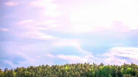 Cloudscape-over-forest-and-treetops---dreamy-time-lapse