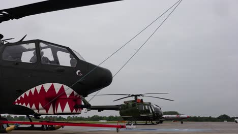 Military-attack-helicopters-parked-at-airport-ramp-during-airshow-exhibition