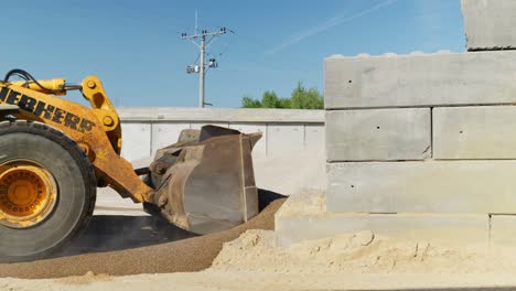 Heavy-duty-wheel-loader-scooping-loose-material-on-construction-site