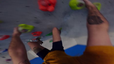 Tattooed-climber-trains-on-an-overhang-artificial-climbing-wall-in-POV