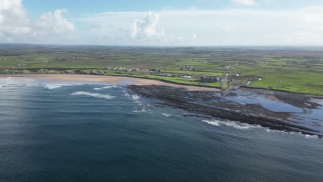 Aerial-establishing-shot-of-Doughmore-Bay-and-Trump-Doonbeg-on-a-summers-day
