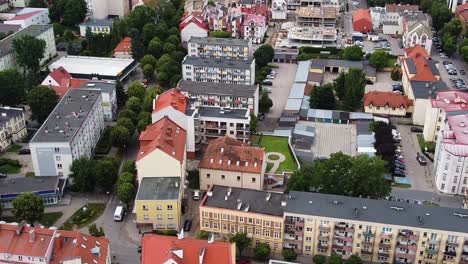 Green-trees-and-urban-living-area-of-Elk-city-in-Poland,-aerial-view