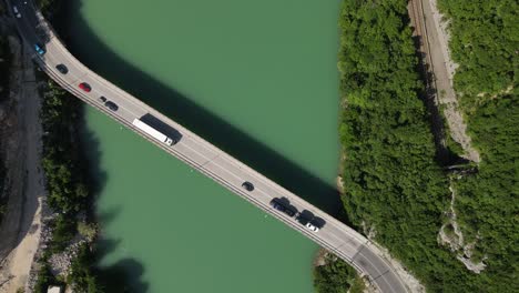 Drone-view-of-the-bridge-built-over-the-Neretva-River,-vehicles-passing-over-the-bridge,-Bosnia