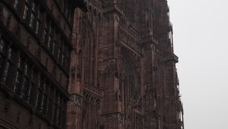 View-onto-the-Strasbourg-Cathedral-against-a-cloudy-sky-backdrop,-its-stones-whisper-tales-of-centuries-past,-and-its-towering-spire-continues-to-inspire-awe-and-wonder-in-all-who-gaze-upon-it