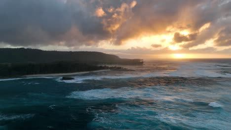 Aerial-drone-video-captures-the-enchanting-golden-hour-sunset-in-Hawaii,-with-big-waves-in-the-ocean