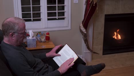 Old-senior-man-alone-reading-and-drinking-on-Christmas-night